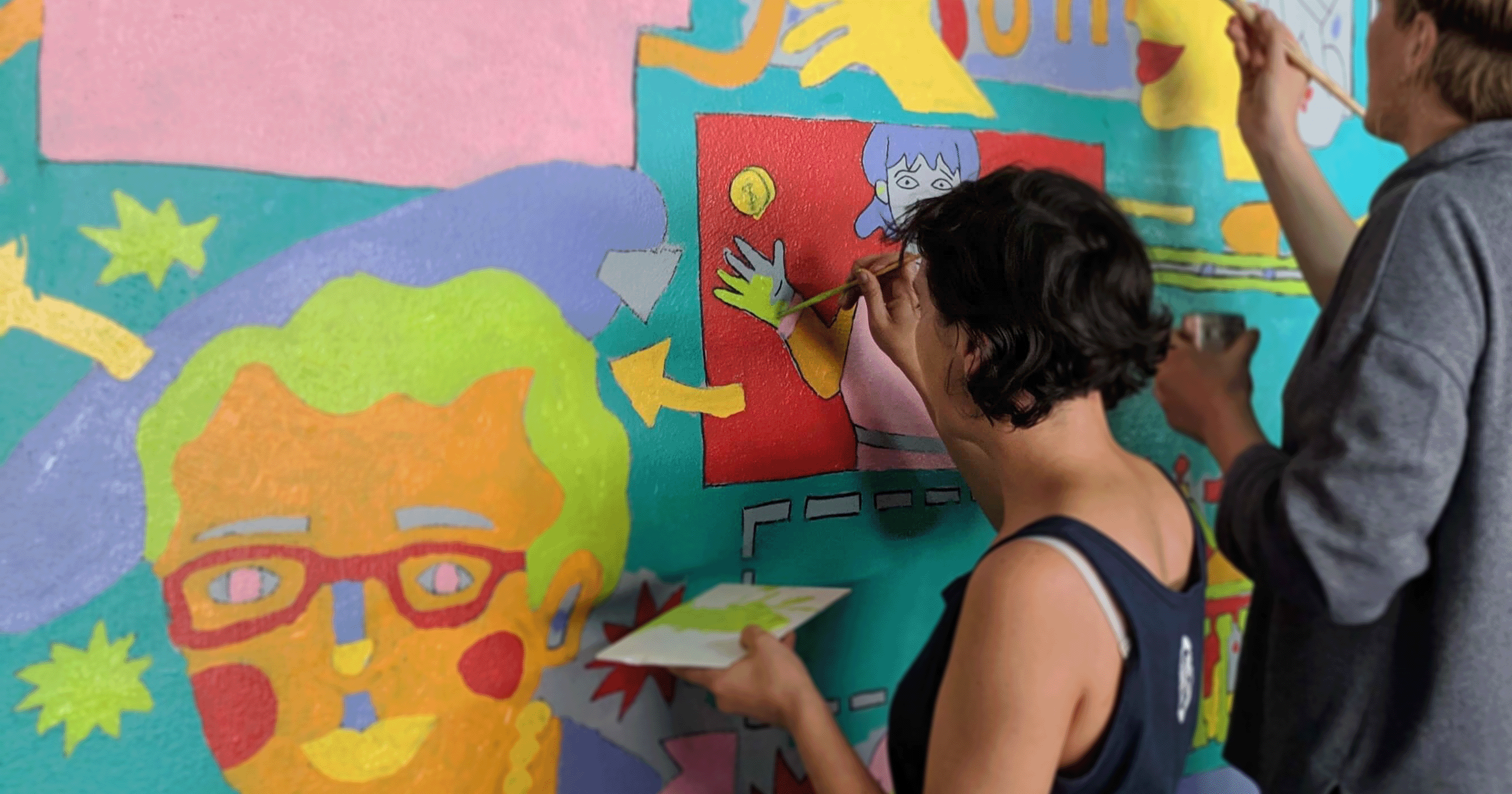 painting a feminist history mural designed by Nicky Minus at Trades Hall Melbourne